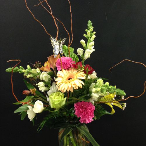 Curly Willow and a Butterfly give this arrangement