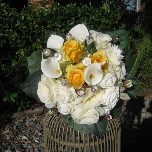 This is a silk bouquet design with large pearls an