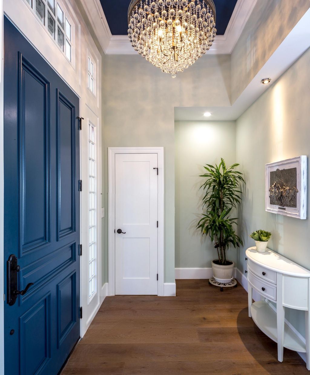 Dark Blue accent Door with light green walls and c