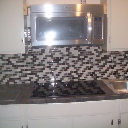 kitchen with custom tile work back splash and coun