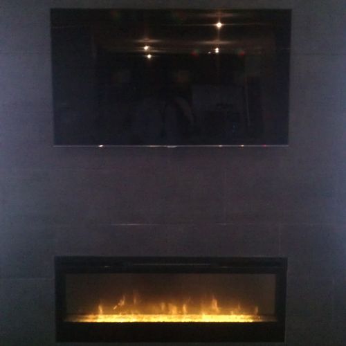50" flat screen TV mounted over ceramic tiled fire