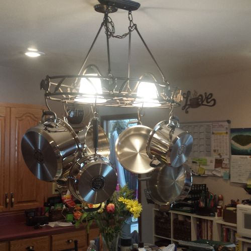 Light fixture in kitchen, also holds pots and pans