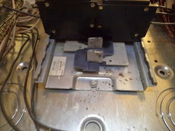 Damaged buss bar in electrical panel.