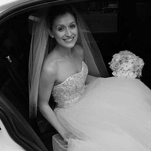 A happy bride in a limousine.