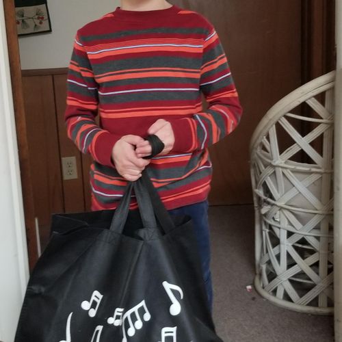 A happy piano student earned a music bag for learn