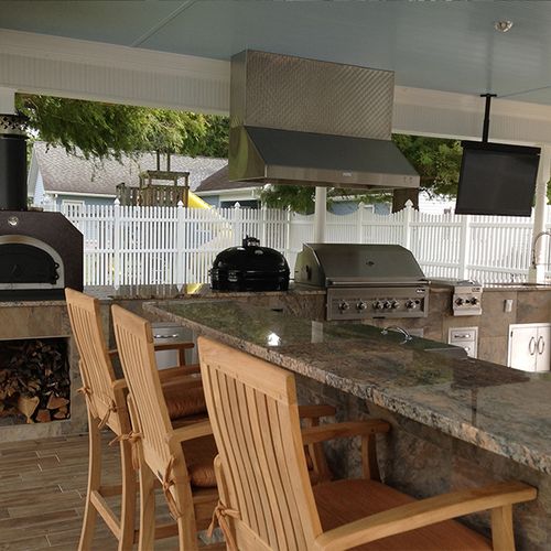 Custom built outdoor kitchen with pizza oven, cera