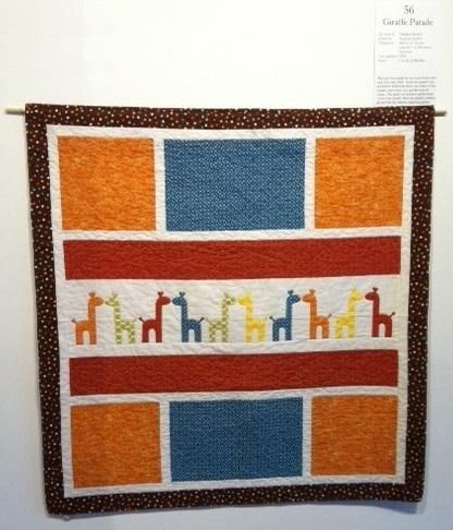 Nursery quilt featuring applique giraffes. Free mo
