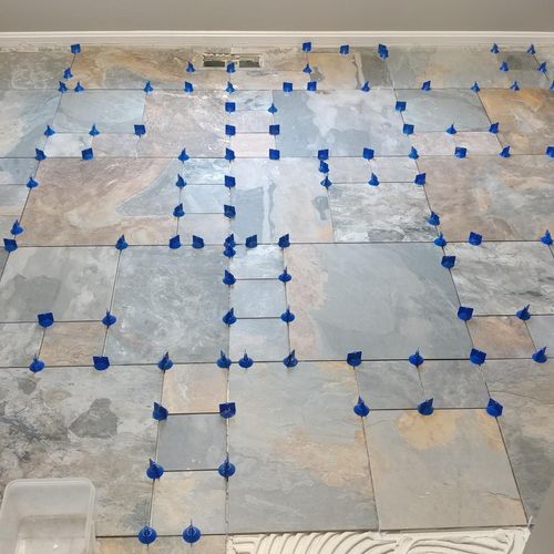 Natural stone tile in pattern w/ levelers 
