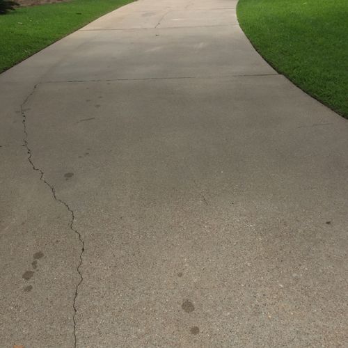 Cleaned driveway with our surface cleaner system.