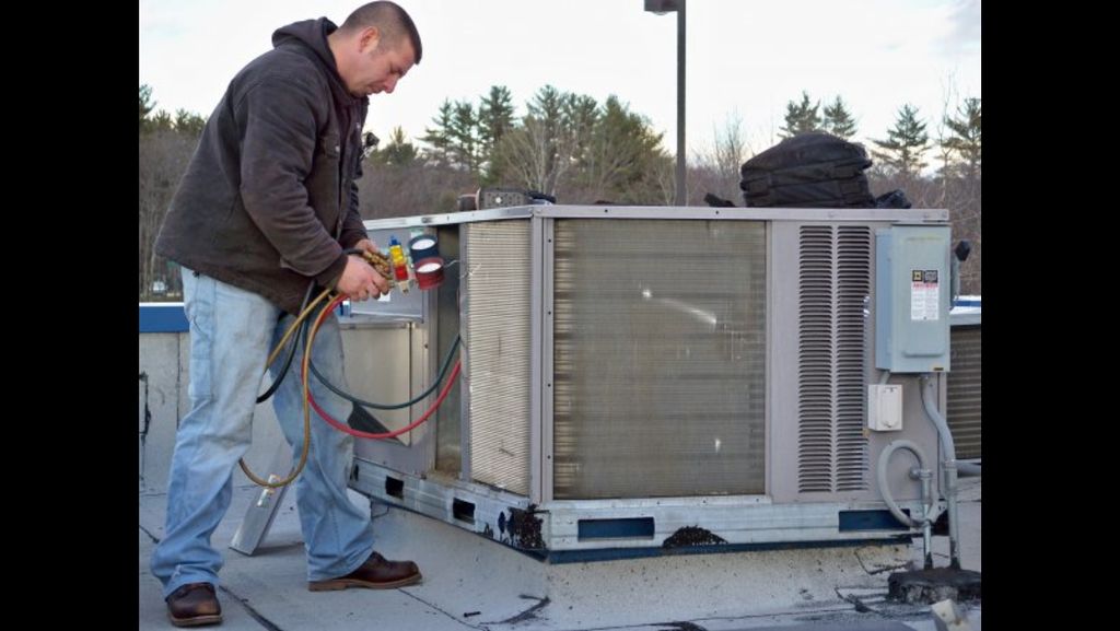 Hard at work on a rooftop, whatever it takes to ge