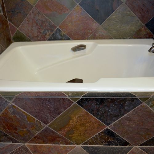Kohler soaking tub with slate tile surround