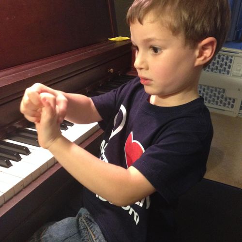 A 3 year old student working on finger-warm ups.