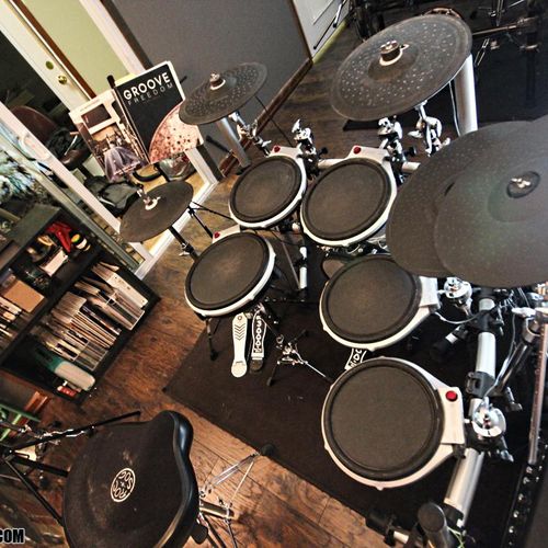 Teaching studio equipped with two drum sets, video