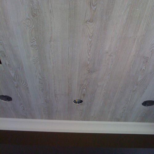 Faux wood wallpaper pattern installed on a ceiling