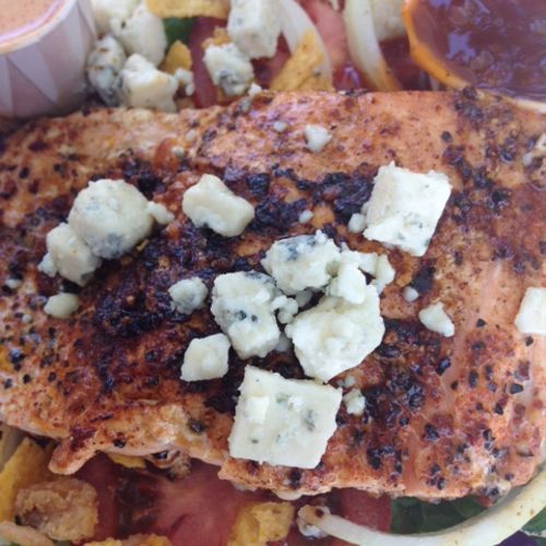 Grilled Atlantic salmon salad topped with gorgonzo