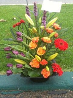 High styled design to include circus roses, red ge