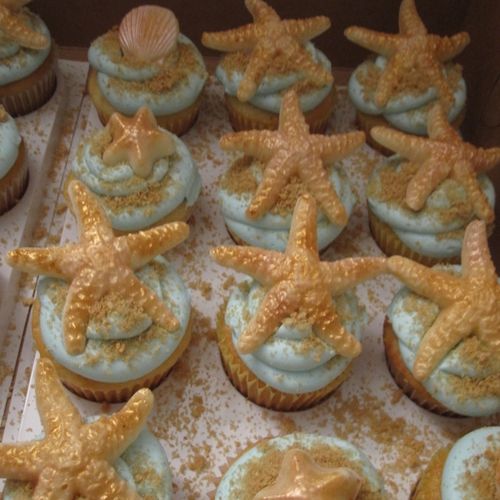 Beach themed cupcakes.  Shells and starfish are ma
