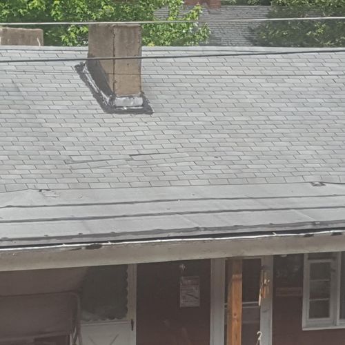 neighbors old roof with loose shingles and leaking