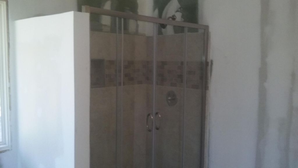 TILE SHOWER AND SHOWER DOORS.