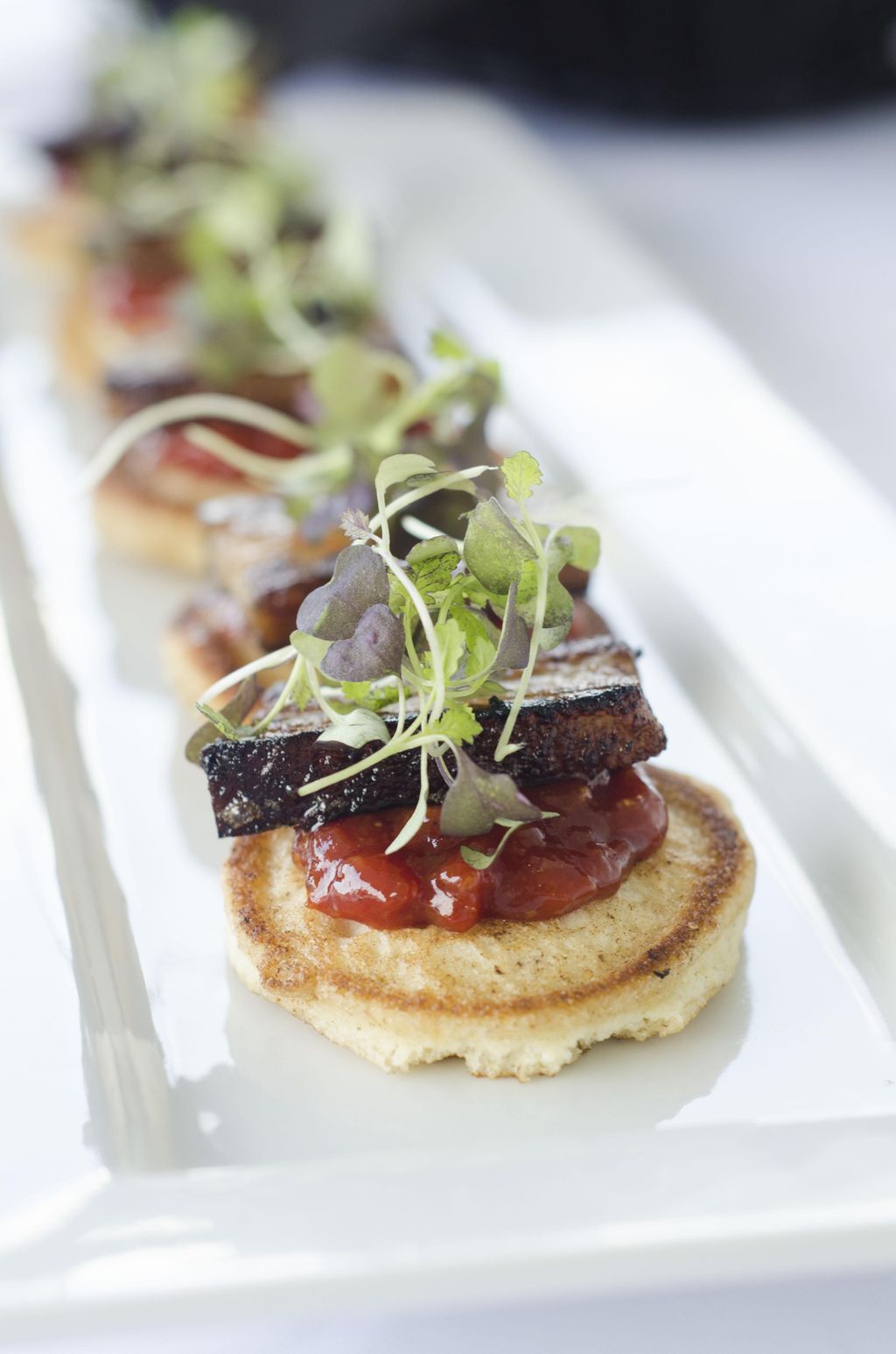 pork belly with corn meal blinis and tomato jam