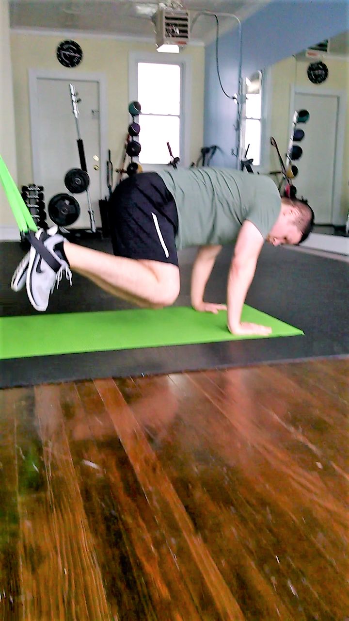 Core workout (suspended knee tucks)