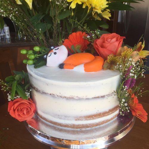 Naked Cake with a sculpted edible fox and fresh fl