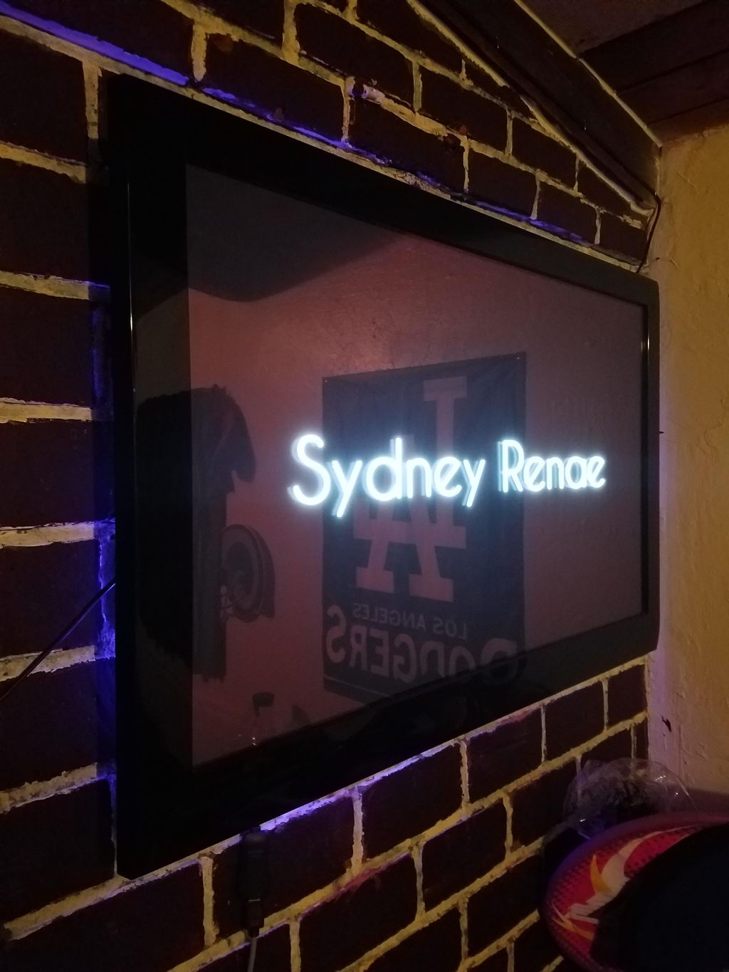 TV Mounted to brick wall with LED Lighting.
