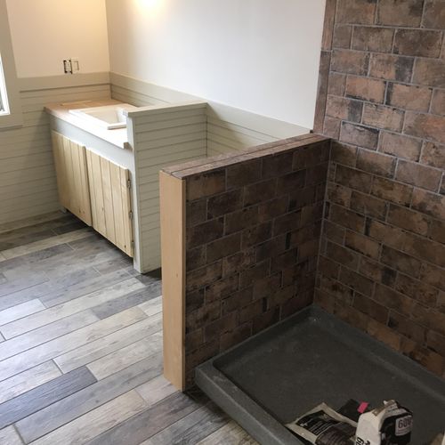 Bathroom with wood tile plank floor and faux brick
