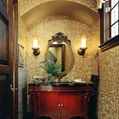 This tudor powder room has a Baker vanity with dra