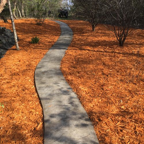 Installation of mulch to existing mulch to brighte