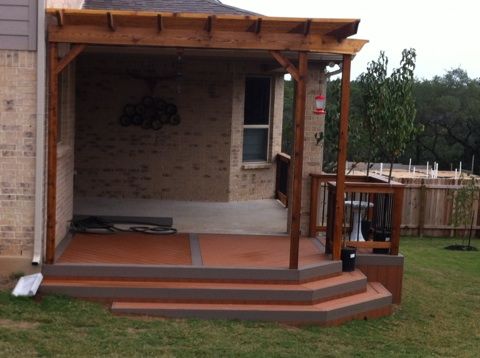A composite deck with a cedar arbor with teared st