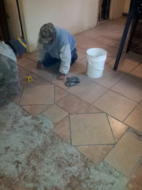 Installation of tile flooring with a design.