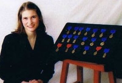 Posing with earned medals from voice competitions.