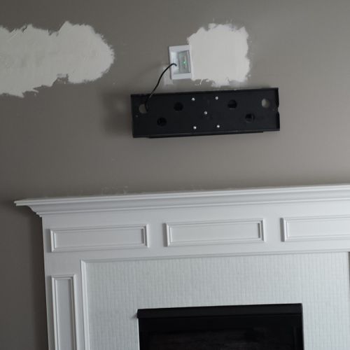 Hide wires and install television over fireplace. 