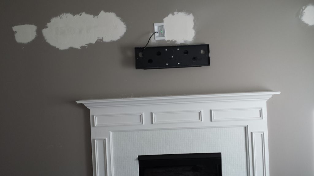 Hide wires and install television over fireplace. 