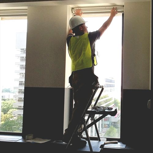 Installing solar roller shades in an office buildi