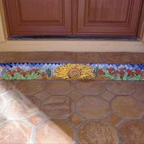 Southwest mosaic installation on step at entryway