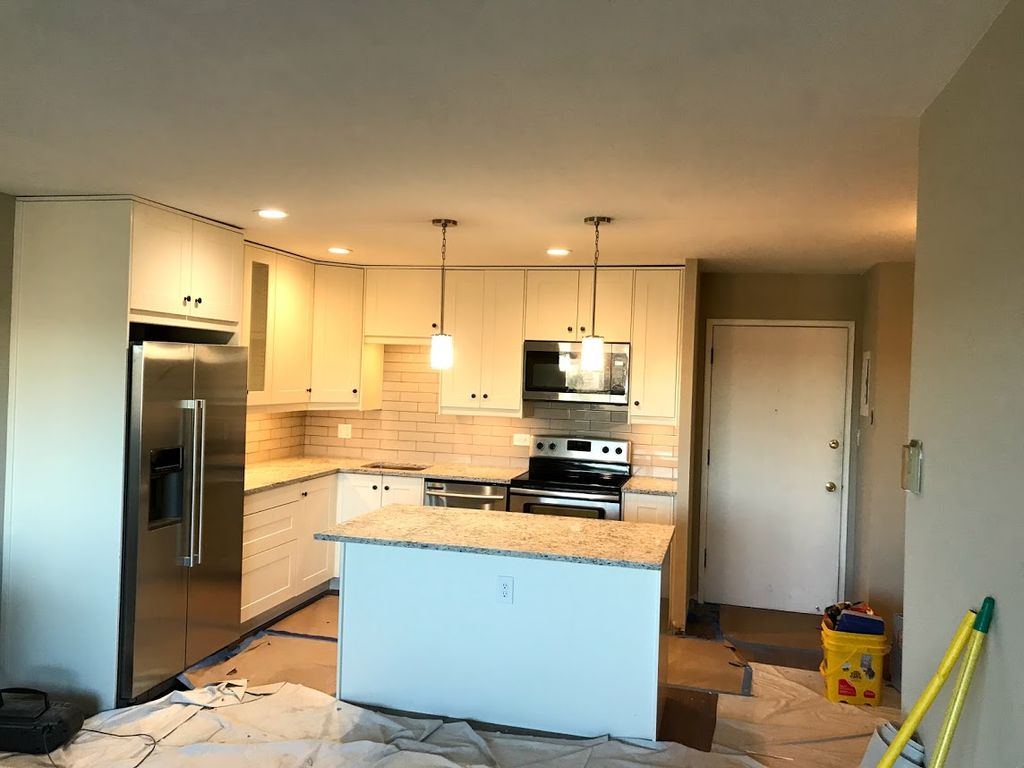 Ikea kitchen cabinet install with island.