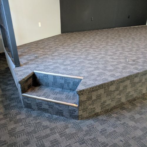 Upholstered stage with pattern match carpet