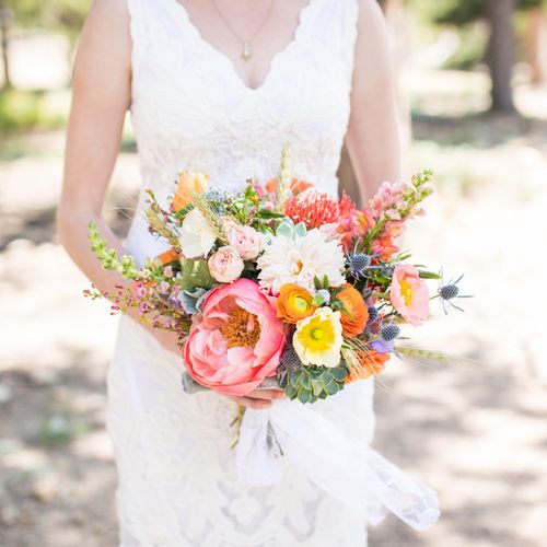 Brides bouquet with peonies, poppies, and snap dra