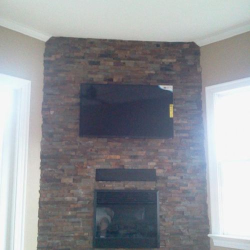 Stacked stone Wall with Fireplace insert and TV mo