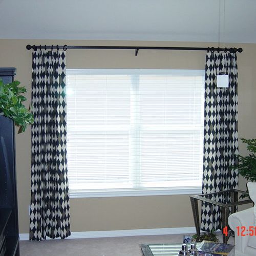Fun black and white custom curtains adorn this bed