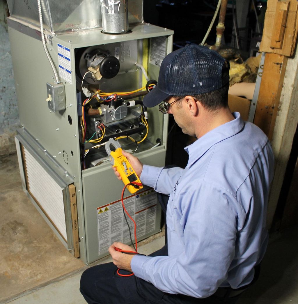 Technician working on a gas furnace.