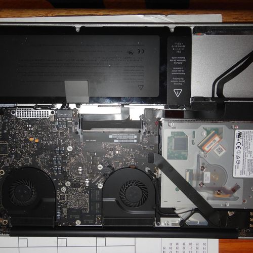 MacBook Pro in the middle of a repair job for a ha