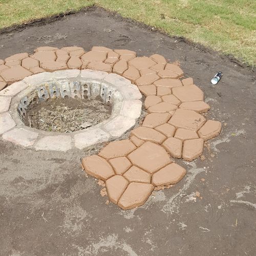 start of a patio with fire pit in the middle 