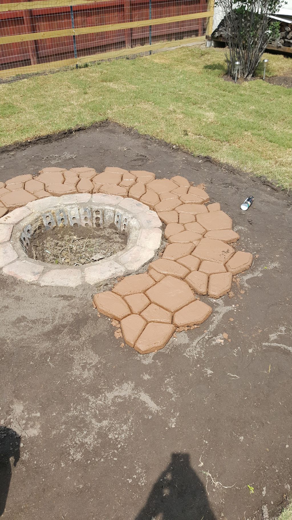 start of a patio with fire pit in the middle 