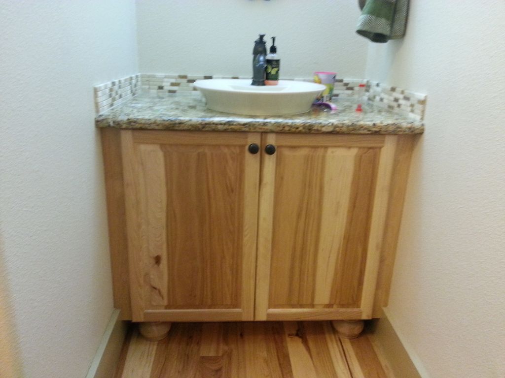 Hickory cabinet in 1/2 bath with granite top