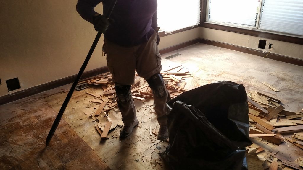 Demoing the old floor in the living room at Elder 