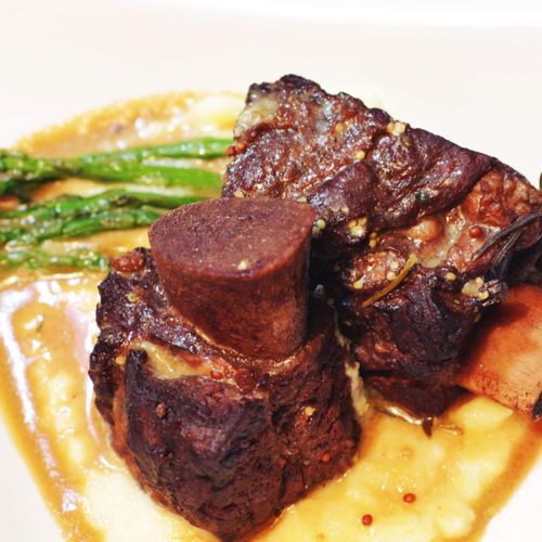Braised short ribs with red wine sauce on creamy c
