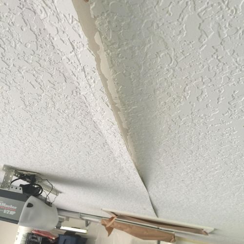 Loose drywall tape on a garage ceiling/before